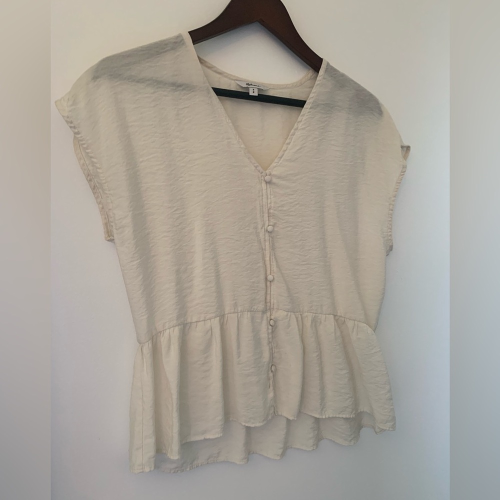 Cream blouse with buttons and slight peplum waist